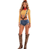 A woman modeling a sexy cowgirl costume consisting of a yellow and red checkered long-sleeve crop top, blue denim shorts, brown suspenders, a brown cowboy hat, a red neck gaiter, and brown cowboy boots.
