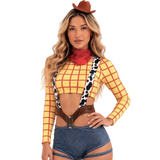 A woman modeling a cowgirl costume top with a yellow and red check pattern, cow-print suspenders, a red neck scarf, and a brown hat.