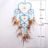 Heart-shaped dreamcatcher with feathers and measurements on a white background