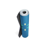 Roll of blue yoga mat with black and white ends on a white background